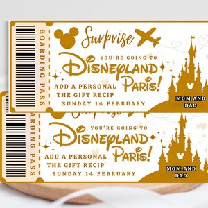 May include: Two gold-colored Disneyland Paris boarding passes. The tickets feature the Disneyland logo, a castle silhouette, and the text "Surprise, You're Going to Disneyland Paris!" with "Mom and Dad" at the bottom. The date is Sunday, February 14.