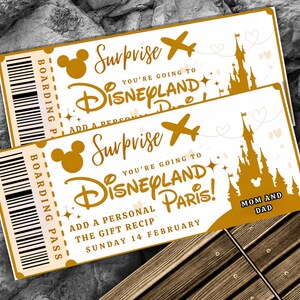 May include: Two golden Disneyland Paris surprise tickets. Each ticket features a boarding pass, Mickey Mouse silhouettes, an airplane, a castle, and the text "Surprise, You're going to Disneyland Paris!" and "Mom and Dad."