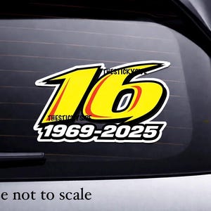 May include: A yellow and black sticker with the number "16" in a racing style font. The sticker also includes the text "THESTICKYSHOP" and the years "1969-2025". The sticker is on a car window.
