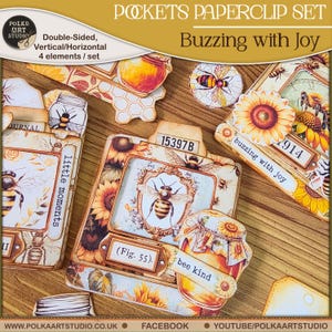 Op de afbeelding: Een paperclipset met een bijenthema. De set bevat dubbelzijdige, verticale en horizontale elementen. De ontwerpen bevatten bijen, zonnebloemen, honingpotten en de tekst "Buzzing with Joy", "bee kind" en "little moments".