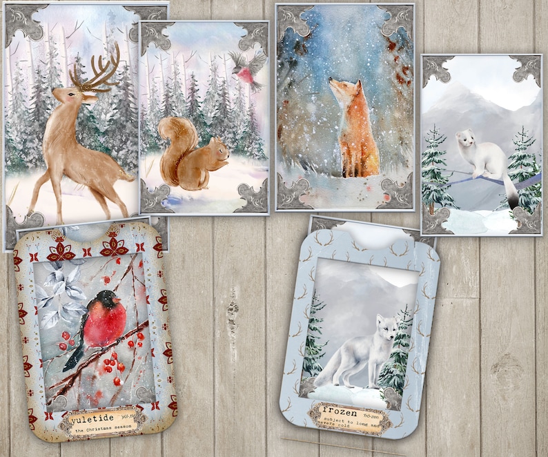 May include: A set of 10 winter-themed greeting cards featuring various animals in snowy landscapes. The cards are decorated with a white border and a gold frame. The cards include a deer, a squirrel, a fox, a white cat, and a robin.