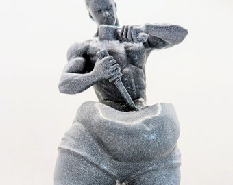 May include: A gray 3D printed figurine of a person with a muscular build, holding a knife in their right hand and a hammer in their left hand. The person is wearing pants with a large, round bulge in the front.