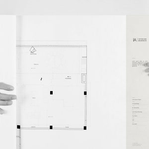 May include: Black and white blueprint of a floor plan with the text "Interior Architects" and the logo "LA" in the top right corner.