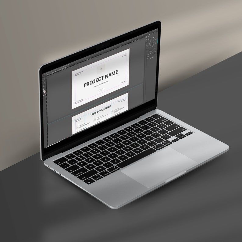 May include: A laptop computer with a silver case and a black keyboard. The screen displays a presentation with the title "PROJECT NAME" and a "TABLE OF CONTENTS" section.
