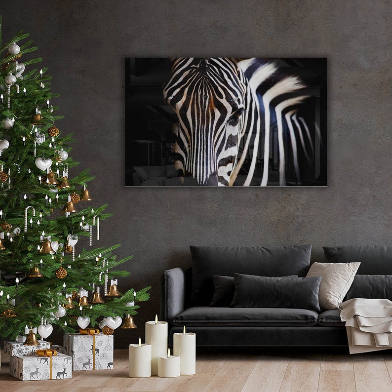 May include: A black and white zebra portrait with a close-up view of its face and stripes. The zebra is against a dark background.