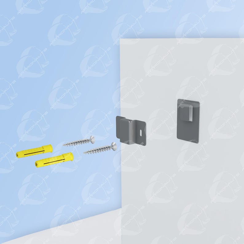 May include: A gray metal bracket with two screws and two yellow plastic anchors. The bracket is mounted to a white wall.