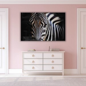 May include: A black and white zebra portrait with a dark background. The zebra's face is in focus, and its stripes are clearly visible.