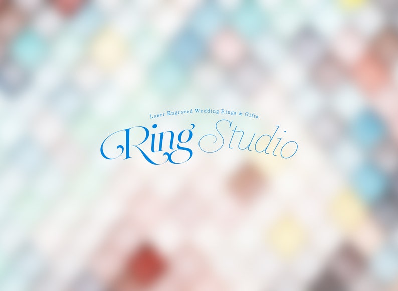 May include: A blue and white logo on a blurred background. The logo says "Laser Engraved Wedding Rings & Gifts Ring Studio".