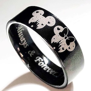 May include: Black ring with a silver engraving of Mickey and Minnie Mouse with hearts. The ring has the words "Always & Forever" engraved on the band.