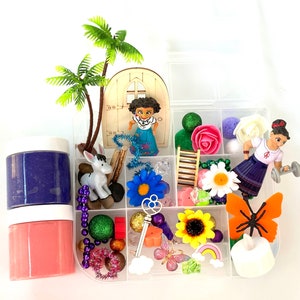 May include: A clear plastic storage box filled with colorful toys and trinkets. The box has multiple compartments and includes a small wooden house, a doll, a donkey, a butterfly, flowers, and a rainbow.