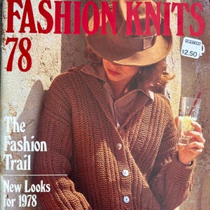 May include: A vintage knitting pattern magazine cover titled FASHION KNITS 78 featuring a brown textured knit cardigan with buttons, a brown fedora hat, and a glass of lemonade. The text includes The Fashion Trail and New Looks for 1978.