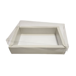 May include: A white cardboard box with a clear plastic lid. The box is empty and ready to be filled with a gift or other items.