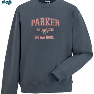 May include: A dark blue sweatshirt with a pink graphic print that says "Parker Est. 2001 No Way Home" with a spider graphic.