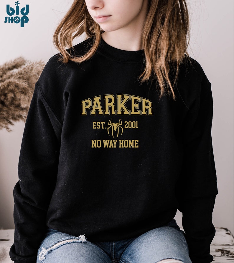 May include: Black sweatshirt with a gold graphic design that says "Parker Est. 2001" with a spider graphic and "No Way Home" underneath.