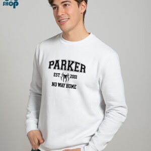 May include: White sweatshirt with a black graphic print of a spider and the text "Parker Est. 2001 No Way Home".