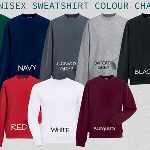 May include: A color chart showing different sweatshirt colors. The colors are: bottle green, navy, convoy grey, oxford grey, black, red, white, and burgundy.