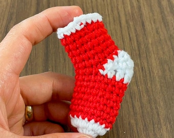 May include: A small red and white crocheted Christmas stocking.
