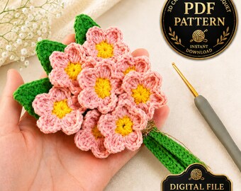 May include: A crochet flower bouquet featuring pink blossoms with yellow centers and green leaves. A grey crochet hook is positioned nearby. The image includes text labels reading 3D CROCHET FLOWER BOUQUET PDF PATTERN INSTANT DOWNLOAD and DIGITAL FILE NO PHYSICAL ITEM.