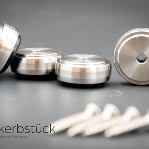 May include: Four silver metal furniture feet with a black rubber base and four silver screws. The furniture feet are designed to protect floors from scratches.