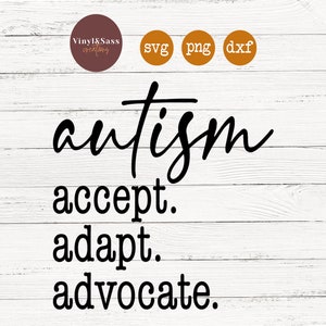 May include: Black text on a white wood background reads "autism accept. adapt. advocate."
