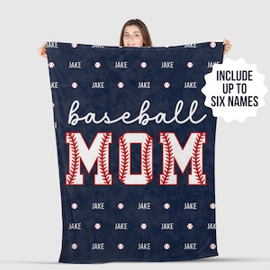 May include: A navy blue fleece blanket with the words "baseball mom" in white and red. The letters are outlined in red and have a baseball stitch pattern. The blanket is decorated with a repeating pattern of the word "JAKE" and baseballs.