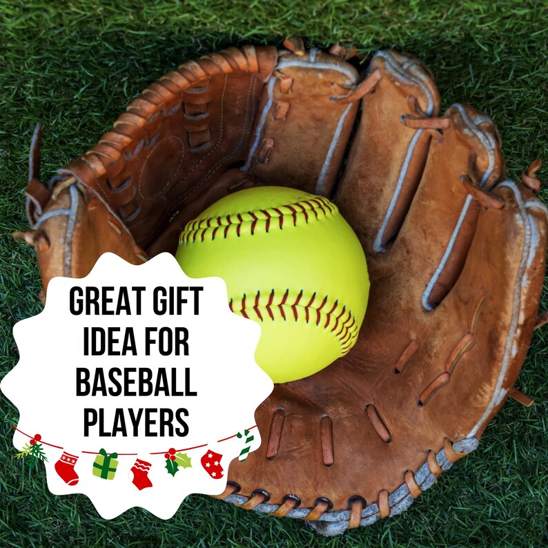 May include: A softball in a brown leather baseball glove on green grass. The softball is yellow with yellow stitching. The glove is worn and has visible stitching. Text on the image reads: GREAT GIFT IDEA FOR BASEBALL PLAYERS.