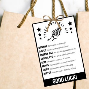 May include: A black and white printable card with the text "Track Survival Kit" and a list of items with descriptions, such as "Banana: Go bananas on the track", "Apple: You are awesome to the core", "Energy Bar: For the energy needed to win", "Chocolate: For a little bit of stress relief", "Gum: Always stick together as a team", "Mints: You were mint to be on our team!", "Chips: You've got this meet in the bag", "Water: To quench your thirst for victory". The card also includes the text "Good Luck!"