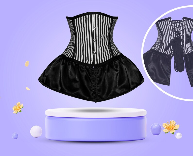 May include: A black and white striped corset with a black satin skirt. The corset has a lace-up back and is displayed on a purple pedestal.