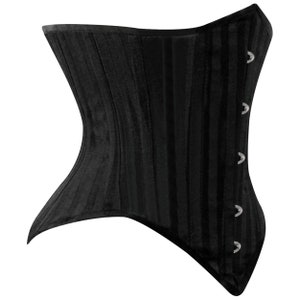 May include: A black corset with a satin finish and a busk closure. The corset has a smooth, sleek design and features a series of metal eyelets along the side.
