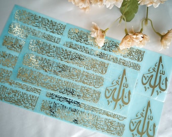 May include: Gold foil stickers with Arabic calligraphy on a light blue background. The stickers feature the word "Allah" in Arabic script.