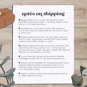 May include: A paper with the text "notes on shipping" and a logo. The text includes information about processing times, delivery, and carrier services. A brown gift box with a tag and eucalyptus leaves are also in the image.