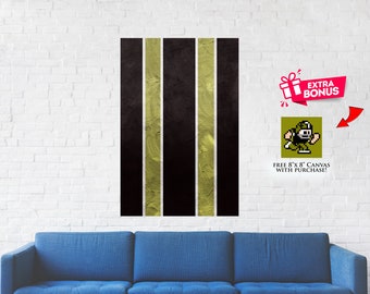 May include: Abstract wall art featuring five vertical stripes in black and gold. The stripes have a textured, brushstroke effect.  Free 8x8 inch canvas with purchase!