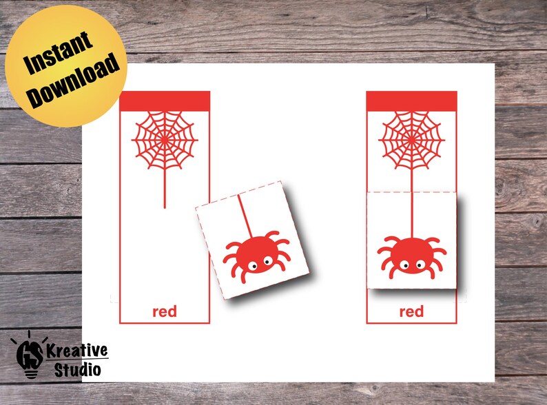 May include: Two red cards with a spider web and a spider hanging from it. The cards say "red" at the bottom.