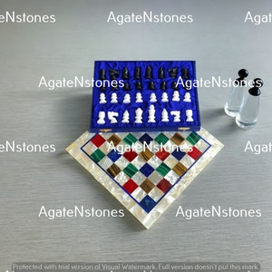 May include: A chess set with a blue velvet lined box and a white and multi-colored agate chessboard. The chess pieces are white and black agate.