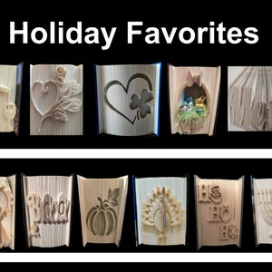 May include: A collection of 10 book folding art pieces, each depicting a different holiday theme. The themes include a heart with a rose, a heart with a shamrock, a nest with eggs, a ribbon with "#1 Dad", "Boo", a pumpkin, a turkey, "Ho Ho Ho", and a menorah.