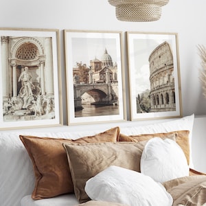 May include: Three framed prints of Roman architecture. The first print shows a fountain with a statue of a man. The second print shows a bridge with a building in the background. The third print shows the Colosseum.