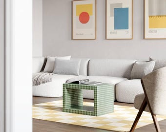 May include: A modern living room featuring a white sectional sofa, a green tiled side table, and a yellow and white checkered rug. Three framed Bauhaus-style art prints hang on the wall. A neutral-toned chair sits to the right.