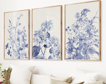 May include: Three framed prints with blue floral illustrations on a white background. The prints feature different floral arrangements, including hydrangeas and other delicate flowers.