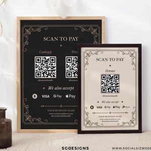 May include: Two framed payment signs with ornate borders. The larger black sign features two QR codes for Cashapp and Venmo, while the smaller beige sign displays one Venmo QR code. Both include text reading SCAN TO PAY and We also accept.