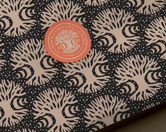 May include: A black and white pattern with a repeating design of stylized trees with crescent moons. The pattern is on a brown surface. A red circle with the text "CANOPY CURE CREATIONS | NATURAL ELIXIRS" is on the surface.