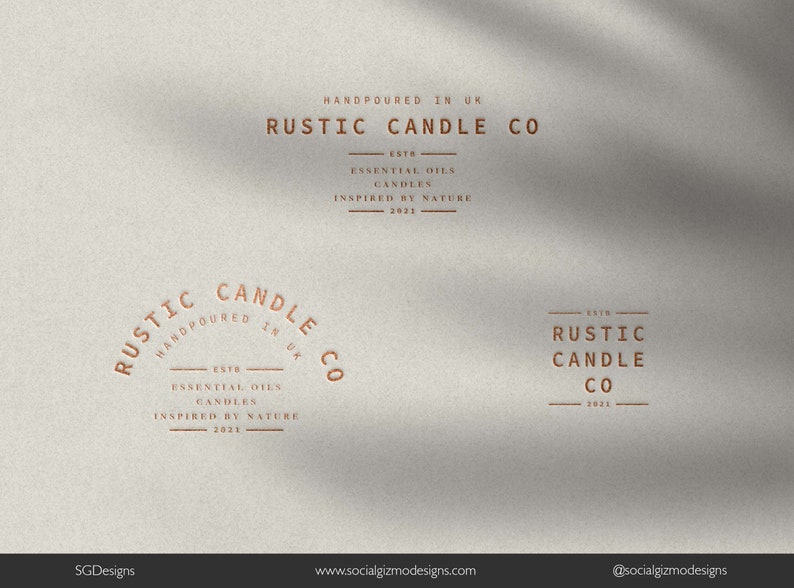 May include: A logo for Rustic Candle Co., a company that makes candles with essential oils. The logo is in a rustic style with a brown color scheme. The text "Rustic Candle Co." is in a large, bold font. The text "Handpoured in UK" is in a smaller font below the company name. The text "Est. 2021" is in a smaller font below the company name. The text "Essential Oils Candles Inspired by Nature" is in a smaller font below the company name.