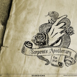 May include: Aged paper with a black and white logo of a snake entwined with a hand, roses, and a banner reading "Serpents Apothecary Est. 2021." The design has a vintage aesthetic, set against a wooden backdrop.