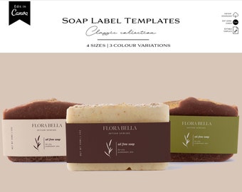 May include: Three soap bars with labels that say "Flora Bella Artisan Skincare" and "Oil Free Soap". The soap bars are brown, beige, and white. The labels are brown with white text and a green leaf design.