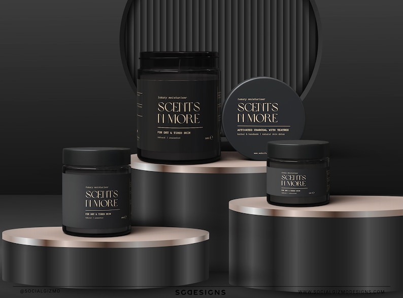 May include: Three black jars with gold lettering that reads "Scent's It More" on a black and rose gold platform. The jars are labeled "Luxury Moisturizer" and contain different formulas for dry and tired skin, activated charcoal with tea tree, and a general moisturizer.