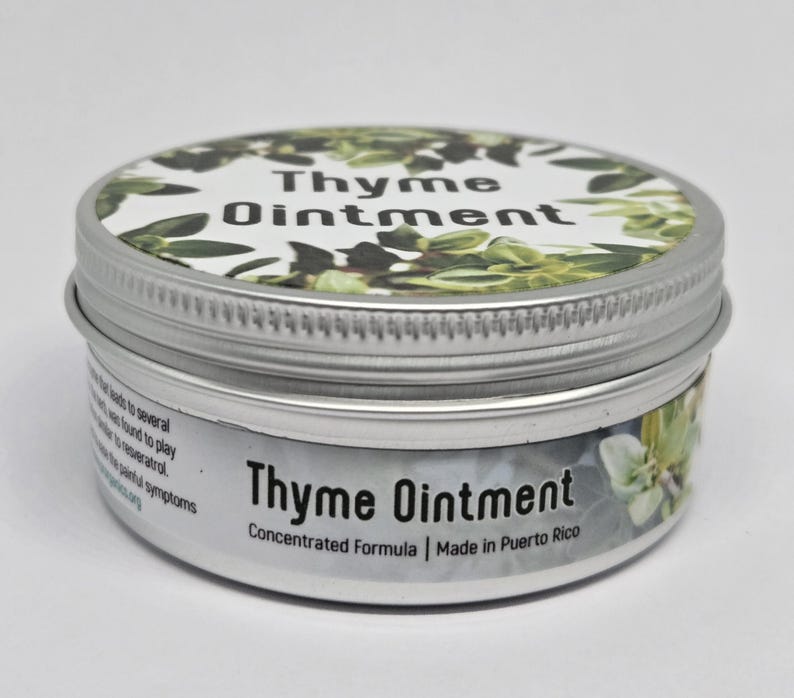 May include: A round silver metal tin containing Thyme Ointment. The lid features a white label with green thyme leaves and the text Thyme Ointment. The side label displays the text Thyme Ointment, Concentrated Formula, Made in Puerto Rico.