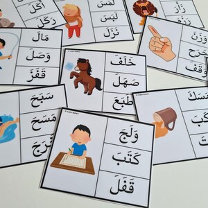 May include: A collection of flashcards with Arabic words and illustrations. Each card features a word in Arabic script paired with a corresponding image, such as a horse, a person swimming, or a person writing. The cards are white with black text and colorful illustrations.