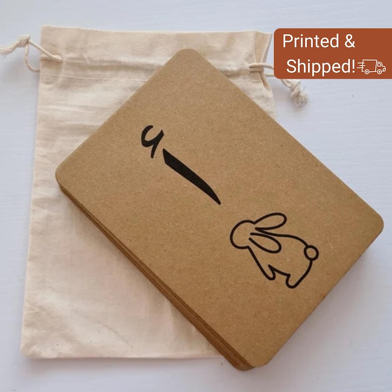 May include: A stack of brown rectangular cards with a black line and a bunny illustration. The cards are next to a beige drawstring bag. The text "Printed & Shipped!" is in a brown rectangle.
