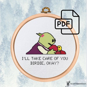 May include: Cross stitch pattern featuring a green character holding a red bird with the text "I'll take care of you birdie, okay?" in a white embroidery hoop.