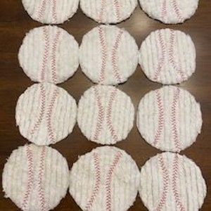 May include: Twelve white cotton coasters with a red baseball stitch design.