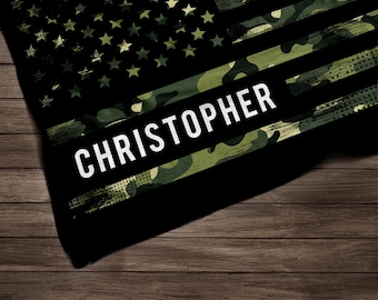 May include: A black and green camouflage American flag with white stars and the name "CHRISTOPHER" printed across the center.